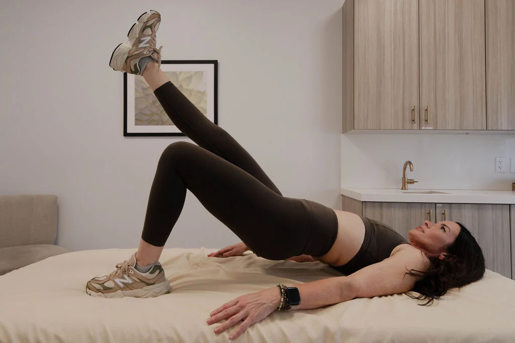 Maureen demonstrating a single-leg bridge exercise